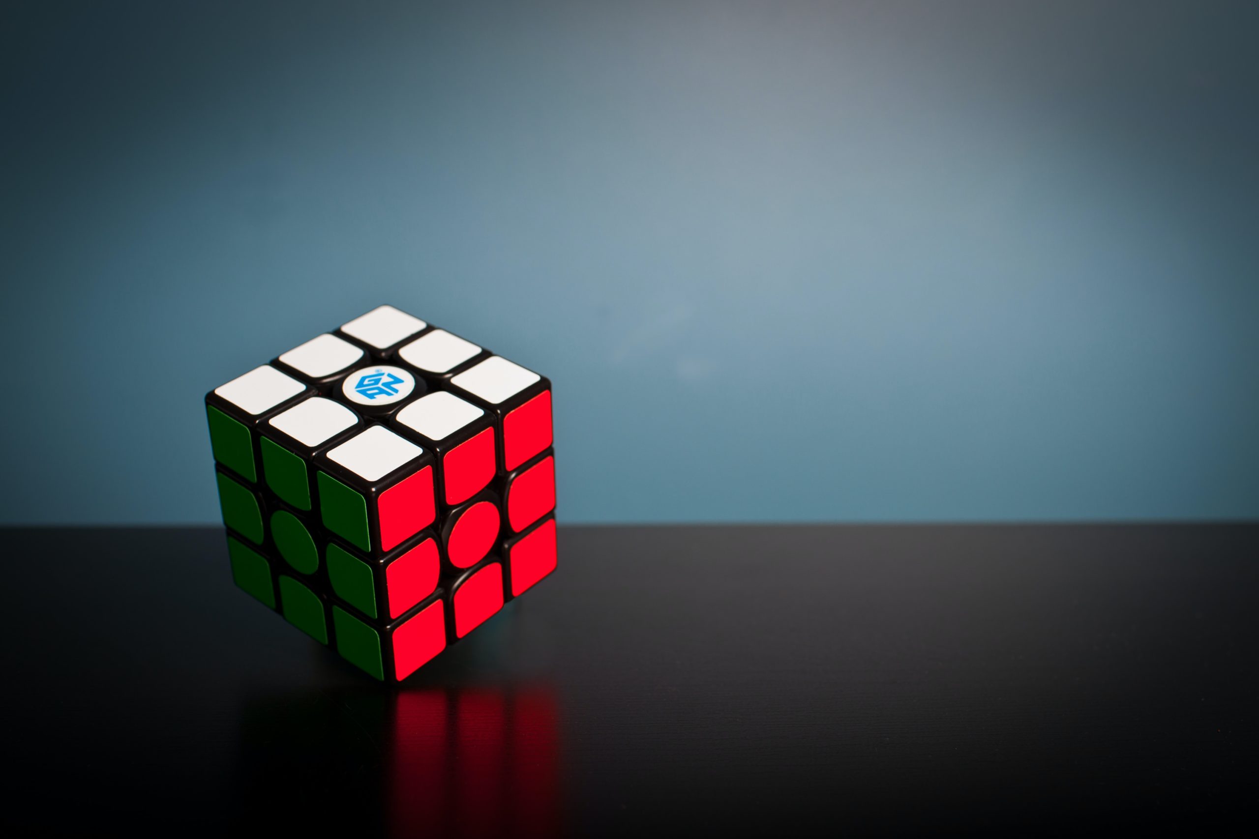 A solved Rubik's Cube spins in an empty background.